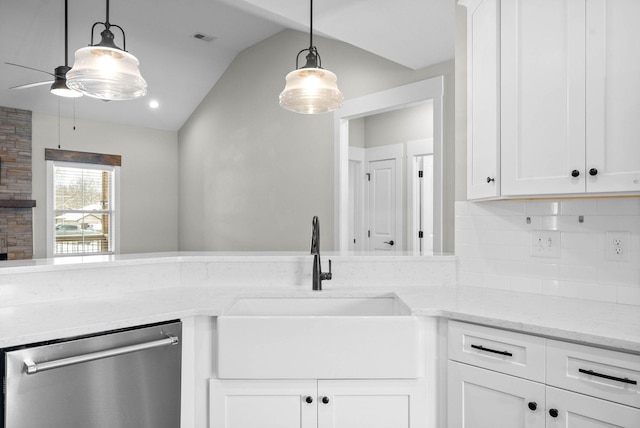 kitchen featuring stainless steel dishwasher, ceiling fan, sink, white cabinetry, and lofted ceiling