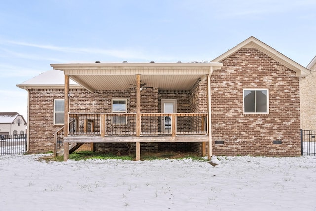 view of snow covered rear of property