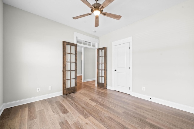 unfurnished room featuring french doors, light wood-type flooring, and ceiling fan