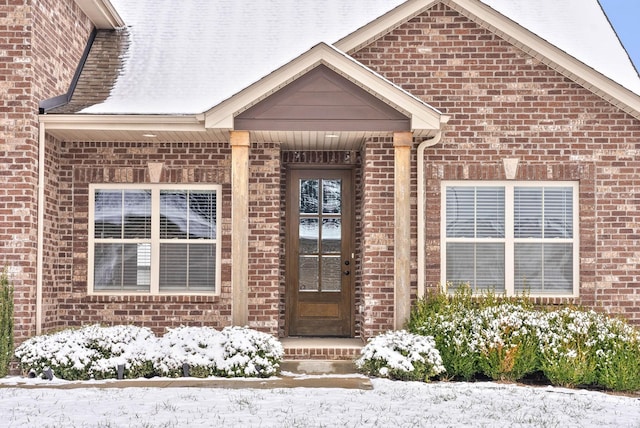 view of snow covered property entrance