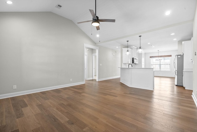 unfurnished living room with ceiling fan, dark hardwood / wood-style flooring, and lofted ceiling