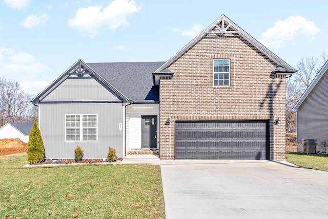 view of front property featuring a front yard, a garage, and cooling unit