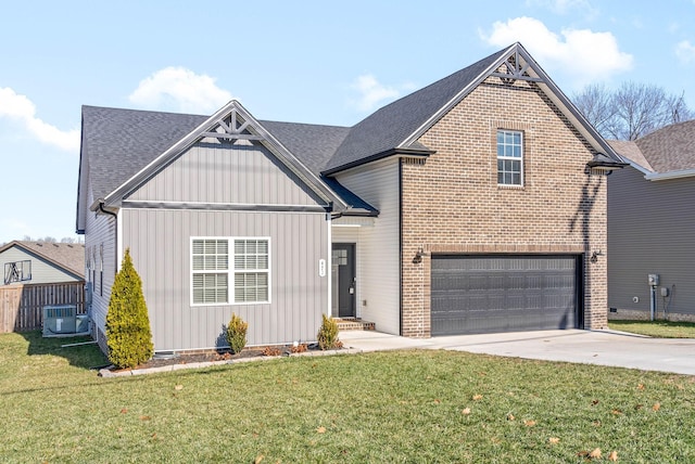 view of front of house featuring a front yard, a garage, and cooling unit