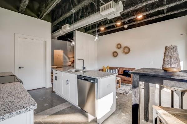 kitchen with dishwasher, white cabinetry, sink, and an island with sink