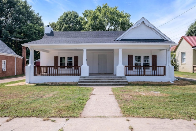 bungalow-style house with covered porch and a front lawn