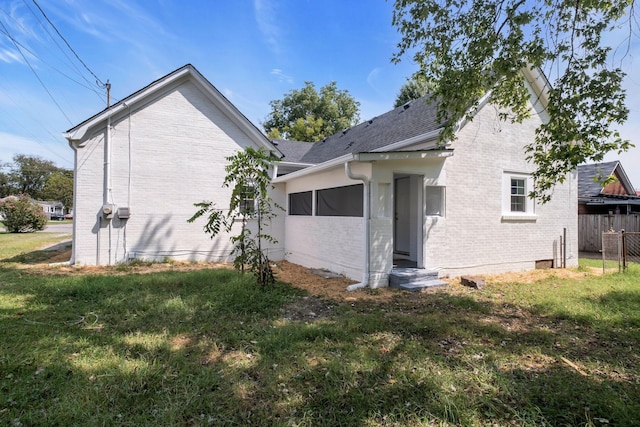 rear view of property with a yard