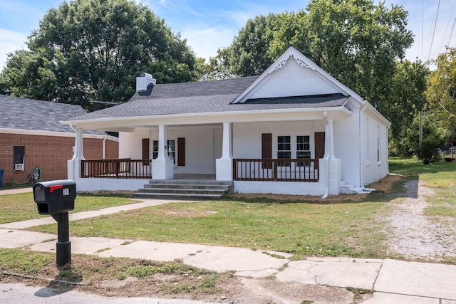 bungalow-style house with covered porch and a front lawn