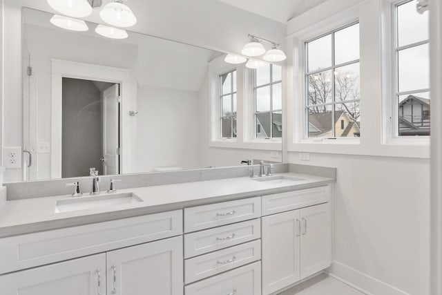 bathroom with vanity and lofted ceiling