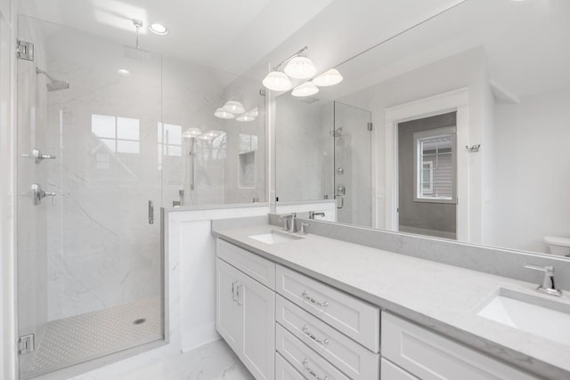 bathroom featuring vanity and a shower with shower door