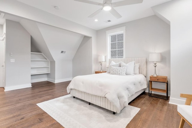 bedroom featuring ceiling fan, dark hardwood / wood-style flooring, and vaulted ceiling