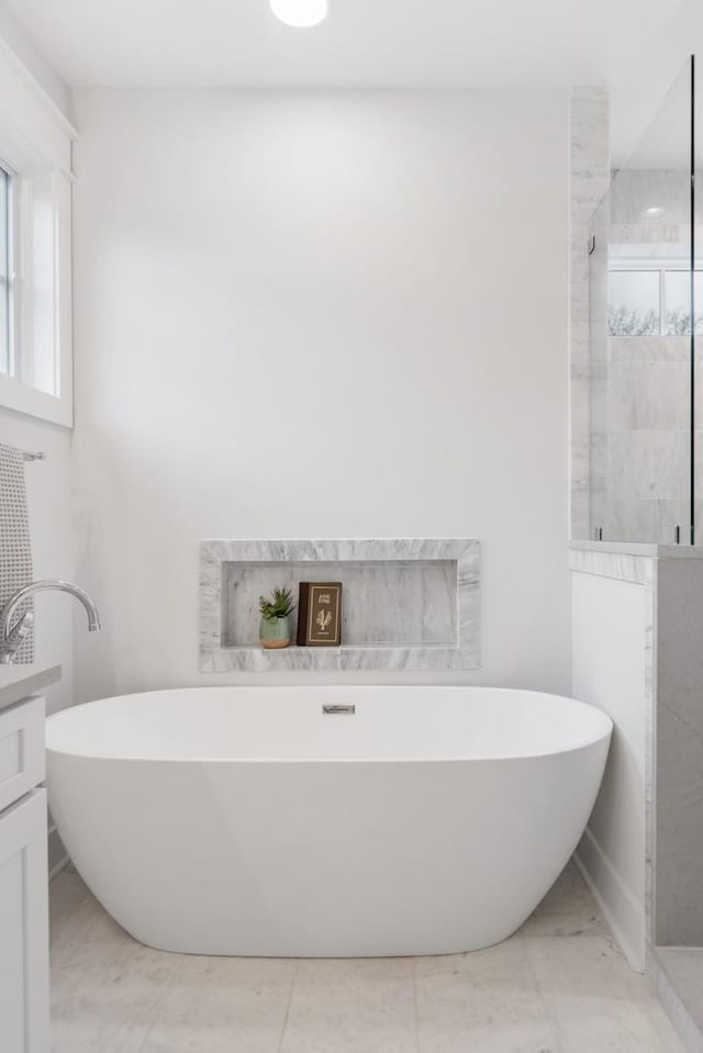 bathroom with vanity and separate shower and tub