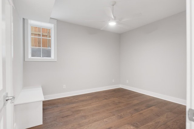 spare room featuring dark hardwood / wood-style floors and ceiling fan