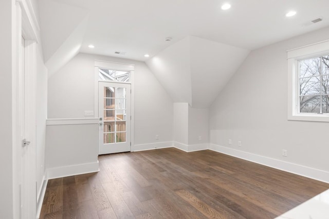 bonus room with plenty of natural light, dark hardwood / wood-style flooring, and lofted ceiling