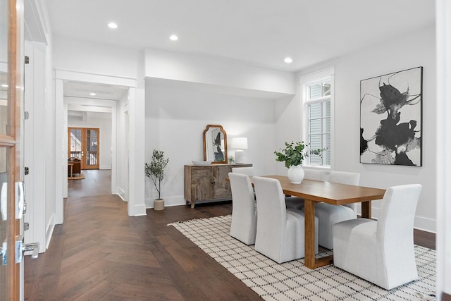 dining space featuring parquet flooring