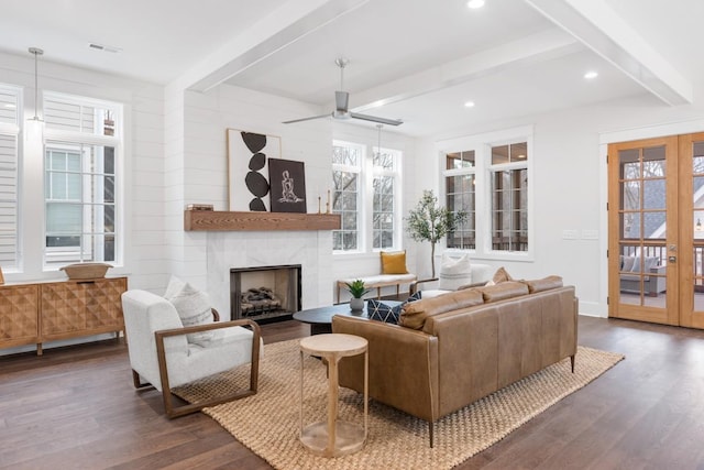 living room featuring beamed ceiling, french doors, and dark hardwood / wood-style flooring