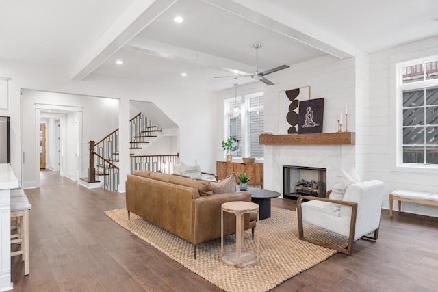 living room with beam ceiling, ceiling fan, dark hardwood / wood-style flooring, and a high end fireplace