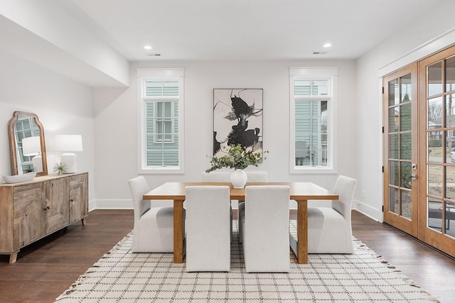 dining space with hardwood / wood-style floors and french doors