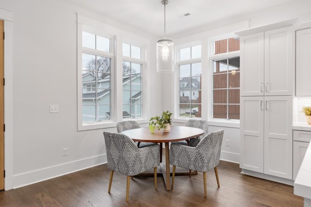 dining area with breakfast area, dark hardwood / wood-style flooring, and a wealth of natural light