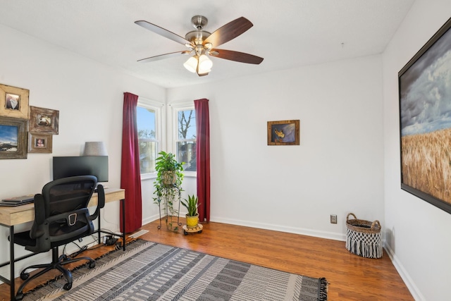 office with hardwood / wood-style flooring and ceiling fan