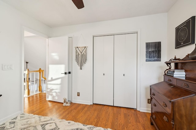 bedroom featuring ceiling fan, a closet, and light hardwood / wood-style floors