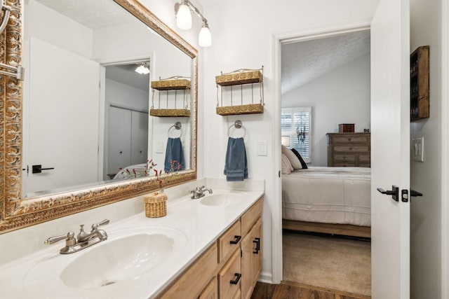 bathroom with vanity, a textured ceiling, and hardwood / wood-style flooring