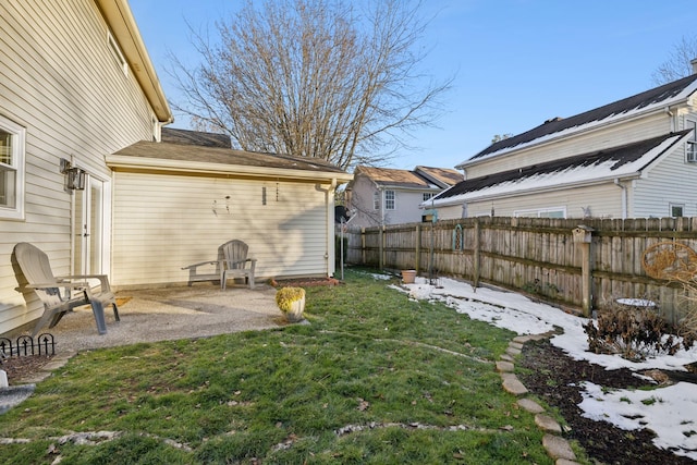 yard covered in snow featuring a patio area