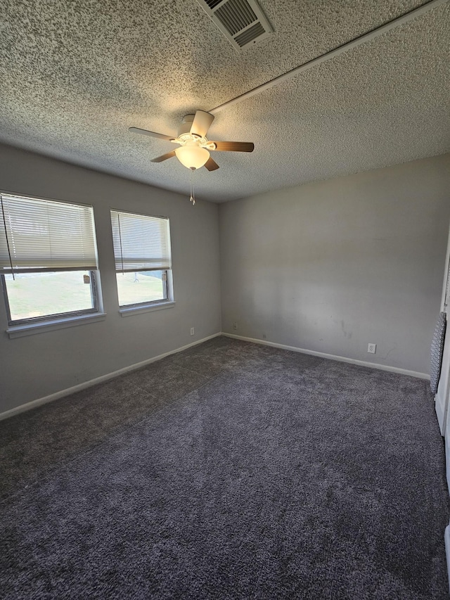 carpeted spare room with ceiling fan and a textured ceiling