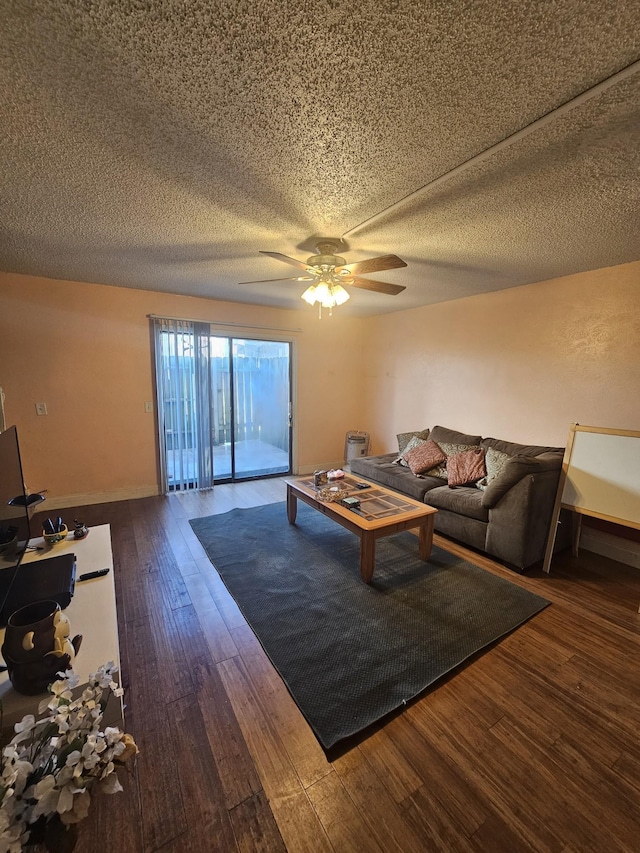 living room featuring dark hardwood / wood-style flooring and ceiling fan