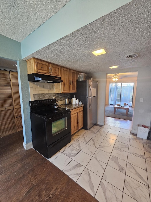 kitchen with stainless steel fridge, ceiling fan, black electric range oven, and backsplash