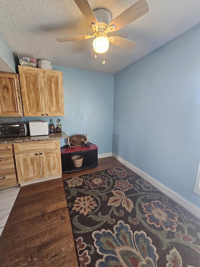 office space featuring a textured ceiling, hardwood / wood-style flooring, and ceiling fan