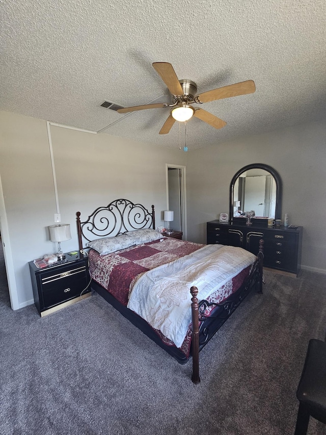 carpeted bedroom featuring ceiling fan and a textured ceiling