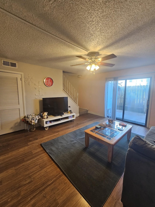 living room featuring hardwood / wood-style flooring and ceiling fan