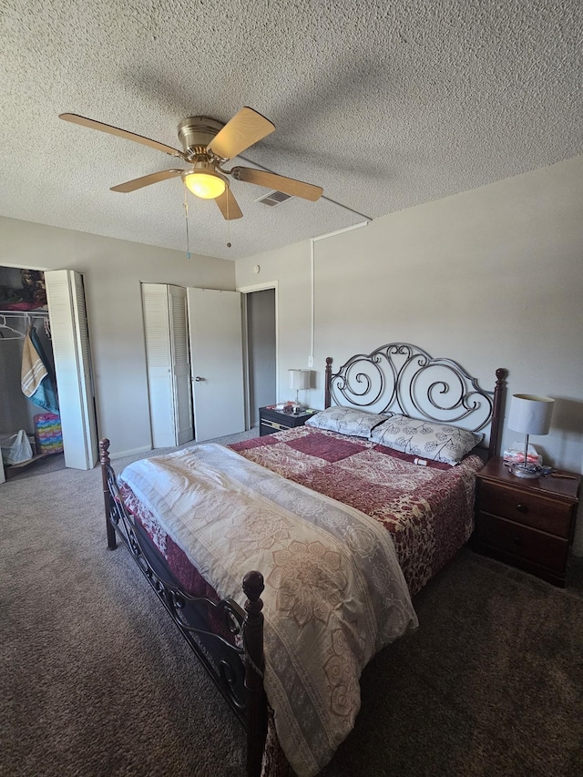 carpeted bedroom with a textured ceiling and ceiling fan