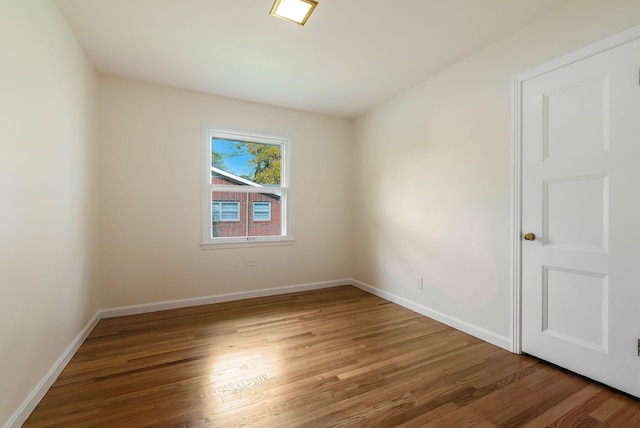 unfurnished room with wood-type flooring