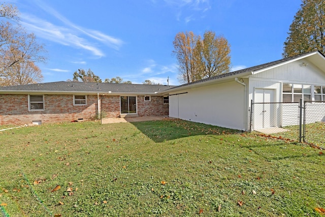 rear view of property with a lawn