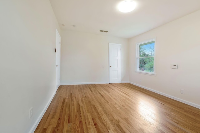 empty room with light hardwood / wood-style flooring