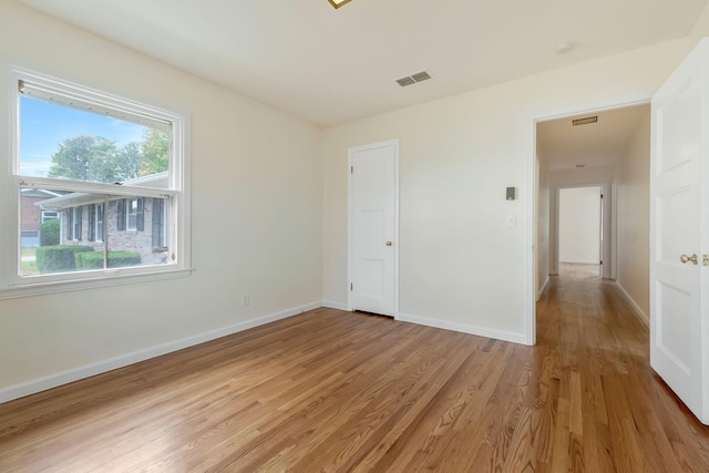 spare room featuring light hardwood / wood-style floors