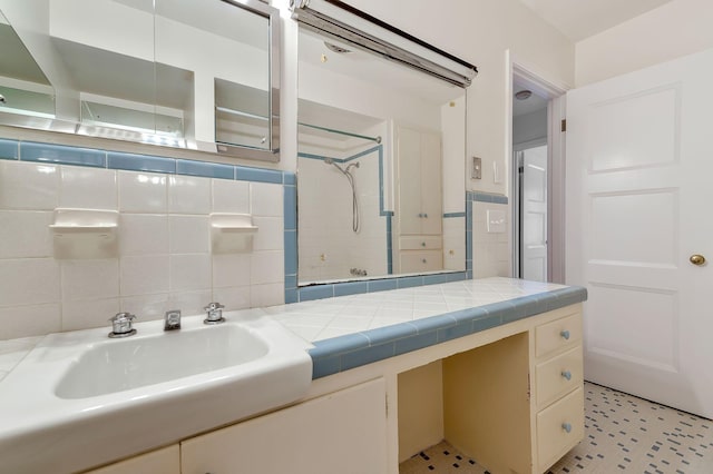 bathroom featuring vanity, walk in shower, and tasteful backsplash