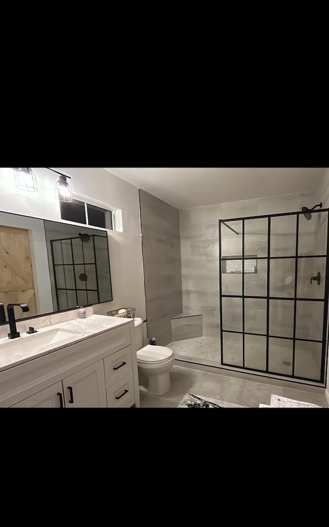 bathroom featuring walk in shower, vanity, and toilet