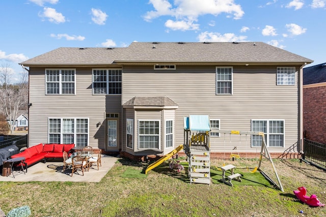 back of house with outdoor lounge area, a patio area, and a lawn