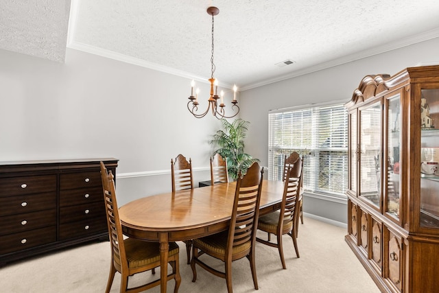 carpeted dining room with a chandelier, a textured ceiling, and ornamental molding