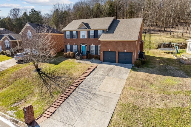 view of front of property featuring a front yard, a trampoline, a garage, and cooling unit