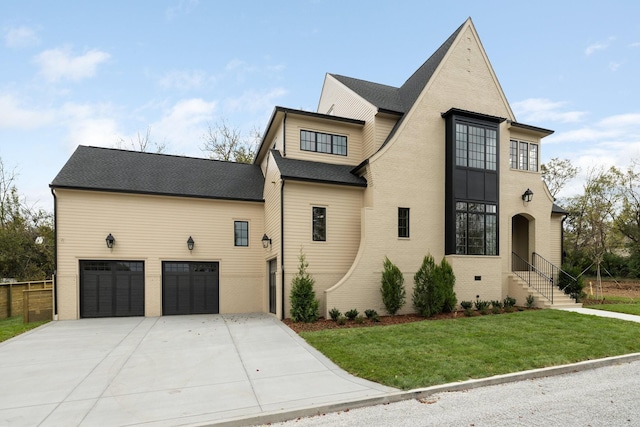 view of front of property with a front yard and a garage