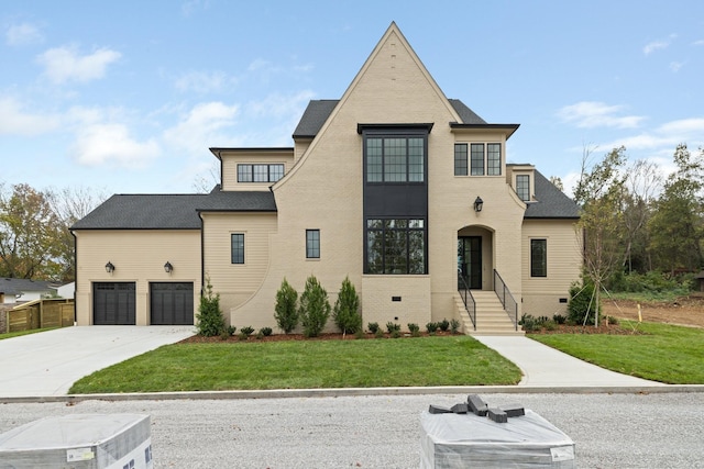 view of front of house with a garage and a front yard