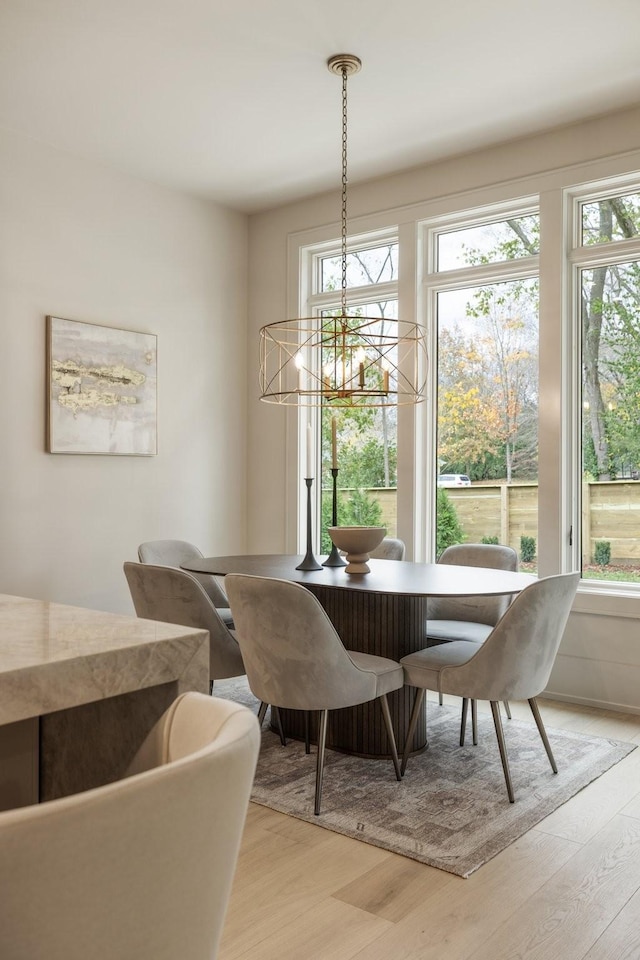 dining room with a notable chandelier and light wood-type flooring