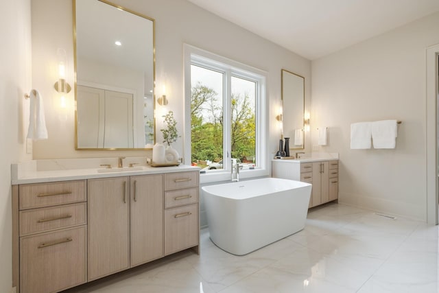 bathroom with a washtub and vanity