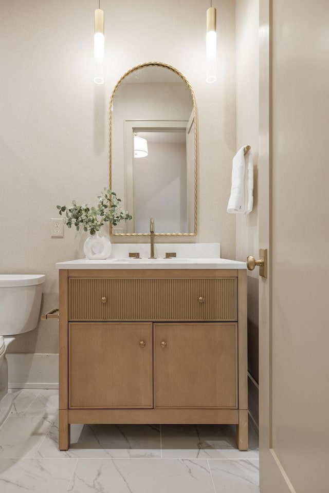 bathroom featuring vanity and toilet