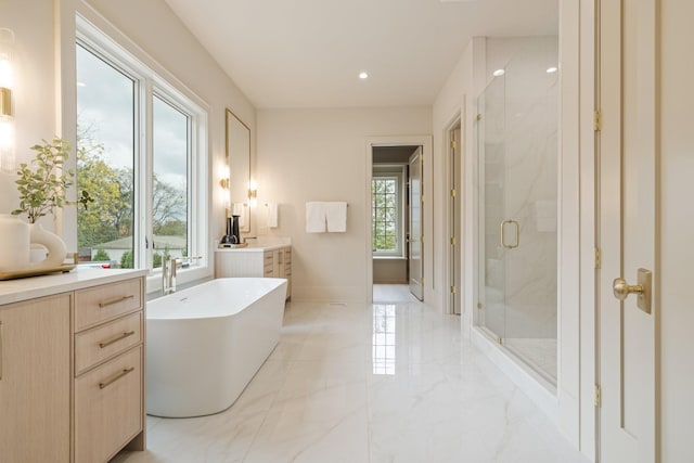 bathroom featuring vanity and independent shower and bath