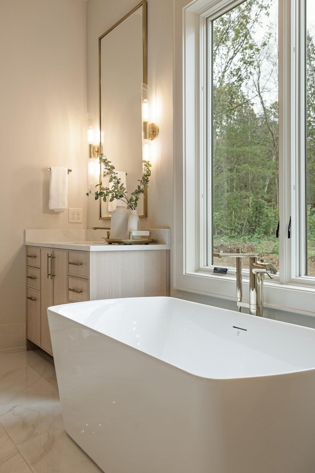 bathroom featuring a tub to relax in and vanity