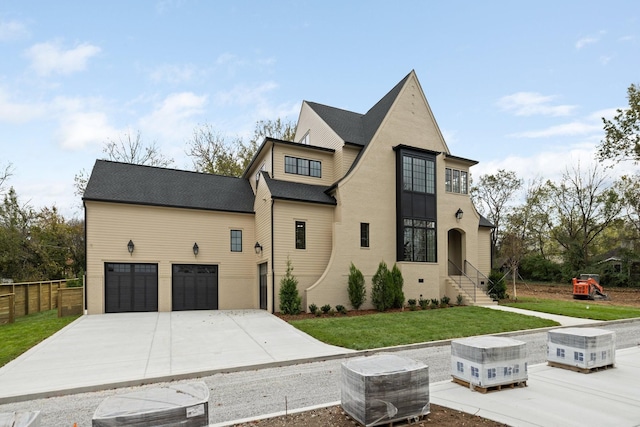 view of front of home featuring a garage and a front yard